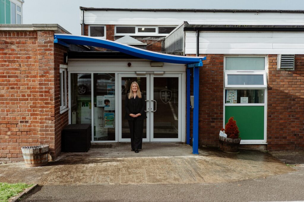 The headmistress standing at the school entrance